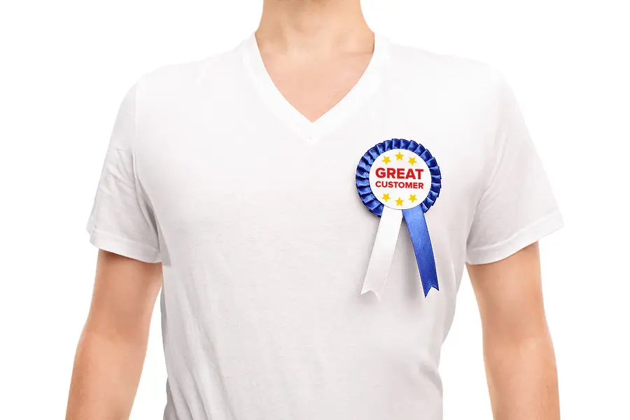 A person wearing a ribbon that reads 'great customer'